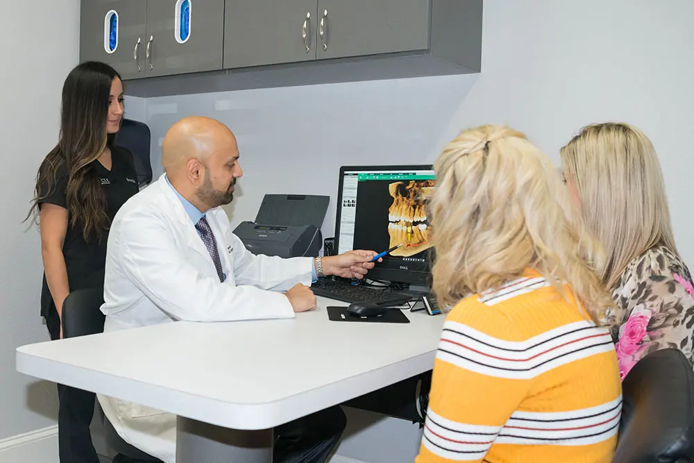 Dr. Parekh with patients | Pinnacle Oral Surgery Specialist